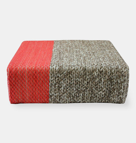 Handmade wool braided square floor pouf in natural grey with offset coral braiding.