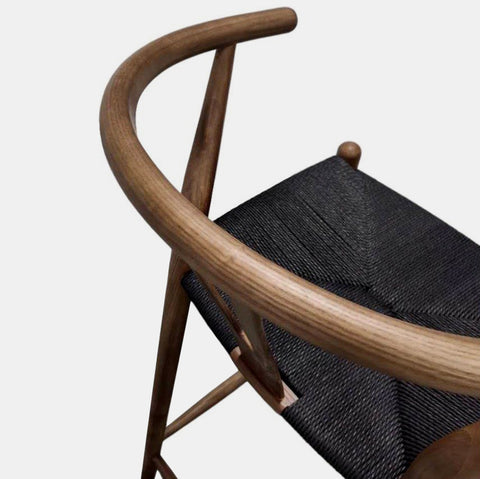 Hans Wegner inspired counter stool in walnut stained ash wood with black cord woven seat.