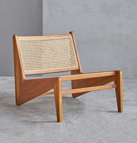 Lounge chair in walnut stained ash wood frame with natural rattan seat and back.