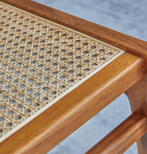 Lounge chair in walnut stained ash wood frame with natural rattan seat and back. Front detail.