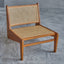 Lounge chair in walnut stained ash wood frame with natural rattan seat and back.