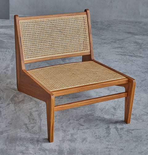 Lounge chair in walnut stained ash wood frame with natural rattan seat and back.