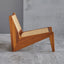 Lounge chair in walnut stained ash wood frame with natural rattan seat and back.