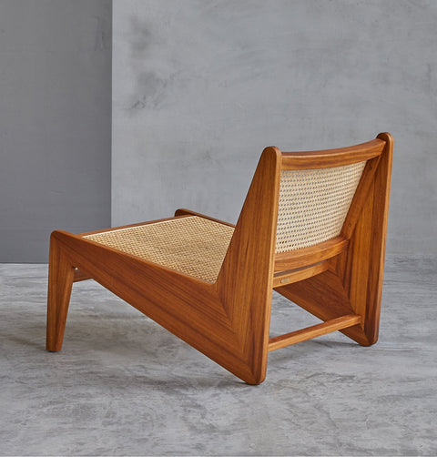 Lounge chair in walnut stained ash wood frame with natural rattan seat and back.