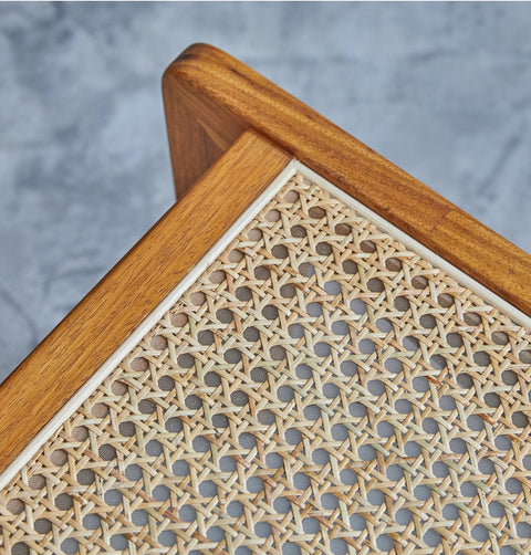 Lounge chair in walnut stained ash wood frame with natural rattan seat and back. Seat detail.