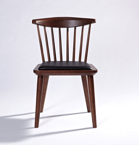 Solid ash wood dining chair in walnut stain finish and black leather seat.