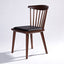 Solid ash wood dining chair in walnut stain finish and black leather seat.