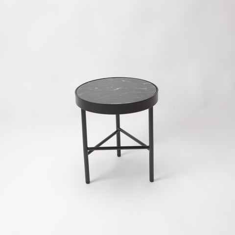 Side table with dark green marble top and black metal frame with 3 legs.