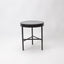 Side table with dark green marble top and black metal frame with 3 legs.