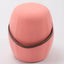 Portable pink cashmere pouf / stool with a brown synthetic leather strap handle.