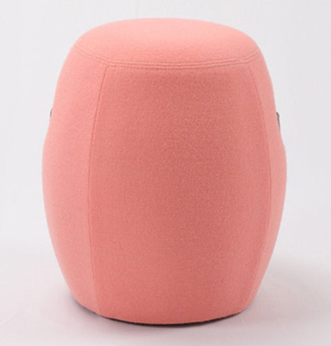 Portable pink cashmere pouf / stool with a brown synthetic leather strap handle.