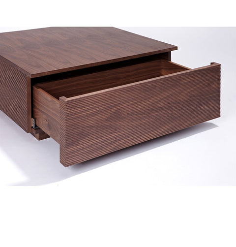 Coffee table in walnut veneer with 2 drawers, and lined ribbing detail. Drawer open.